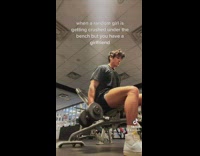 Guy in grey shirt and shorts doing dumbell lifts sitting