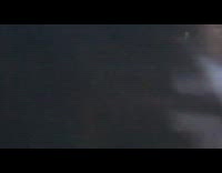 Girl photographs kombucha bottle black railing freeway 