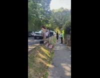 Woman in red outfit poses outside the store