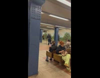 Man pops subway ceiling pimple wet floor