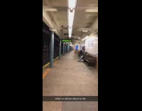 Person talks on subway station intercom speaker