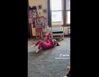 Kid standing suddenly drops on her back 