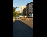 White van pulls mobile concert down street, two girls play guitar on cargo stage, coqueta balloon