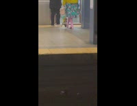 Woman in pink boots and blue dress boards train