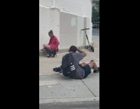 Woman in red leather jacket poses and gets cheered on