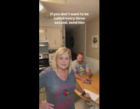 Lady Pranks Husband that Sits beside Kitchen Table