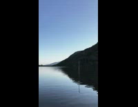 Scenery of a guy paddling on a kayak in the calm waters 
