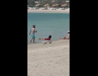 Woman in red bikini lie down on the beach