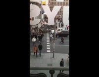 Three girls block black police van street 