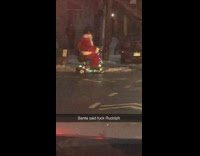 Santa rides mobility scooter decorated with lights 