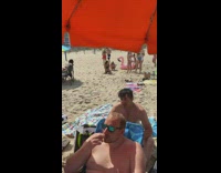 Woman bikini kneel look behind beach photoshoot