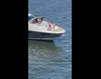 two girls front of yacht pose