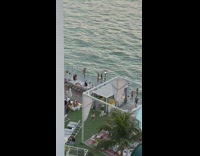 Tourists taking photos on hotel balcony 