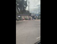 Girl poses inside donut sign parking lot