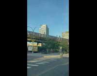 Guys standing atop train subway surfing