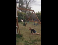 little girl on green backyard kid swing falls off