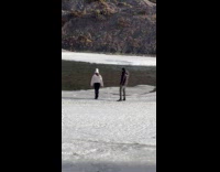 Woman white jacket poses on frozen river