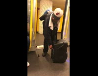 Man carries rolling speakers into subway train and turns it up