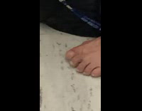 Person on subway touches floor with foot 