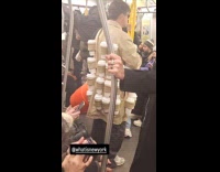 Man wears coat full of coffee cups