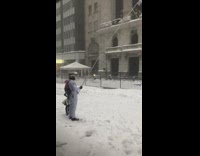 Guy holds stick with doll hazmat suit 