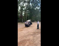 2 guys ride on the back of golf cart 
