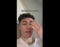 Guy white shirt rubbing eye with finger 