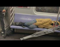 Man with crutches sleep on subway seats