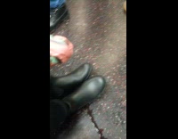 Two sets of matching shoes on subway 