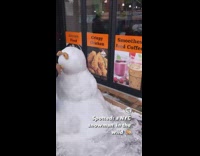 Snowman with bagel as eyes and mouth 