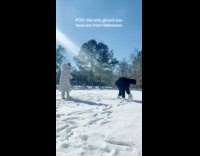 Woman playing with snow with Edward Scissorhands gloves