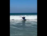 Man lay on surfboard pushed by waves