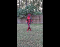 Kid dressed as Deadpool dance on yard