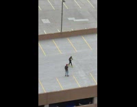 Man in red cap rap video shoot at the parking lot