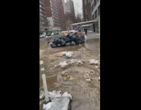 Brown sewer water floods intersection street snow 