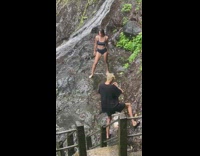 girl stands mud waterfall pics