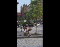 Guy wearing rat mask climbs trash can