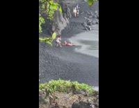 Girl onesie lay black sand raise foot