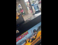 Woman pink boots poses outside the sidewalk