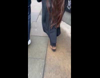 Woman with long hair walks on street