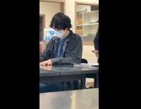 Guy looking over cheating during test 