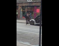 Guy takes picture sports car butterfly doors