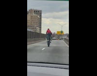 Guy does wheelie on one foot motorcycle 