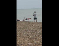 Woman pink top black shorts yoga exercise beach