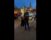 Man in coat poses for street video