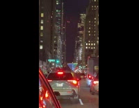 Three guys stand back of white truck 