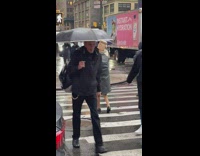 Grandma with Paper Bag on Head Crosses Street