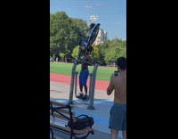 Man shirtless on the air walker with a bike on his head