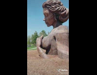 Big sculpture of a woman on sunny day