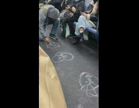 Guy draws faces on train 